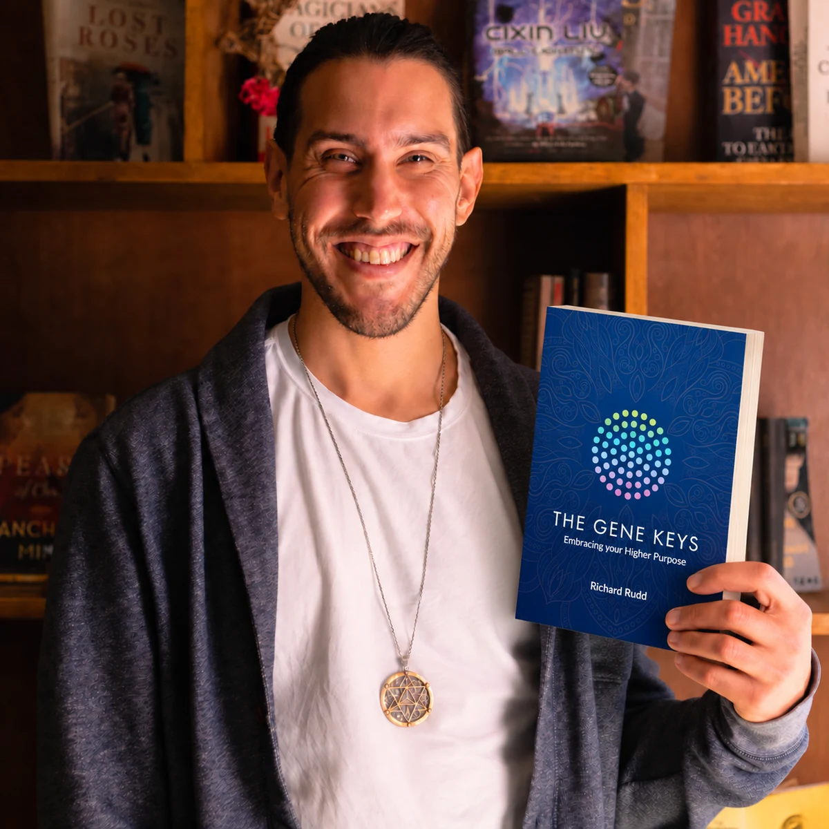 Christopher August holding a copy of The Gene Keys